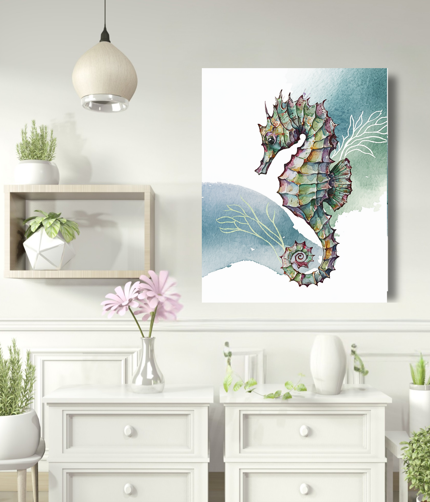 A vertical canvas art print featuring a colorful watercolor seahorse, displayed on a white wall in a styled room setting with a white dresser, plants, and a hanging lamp.