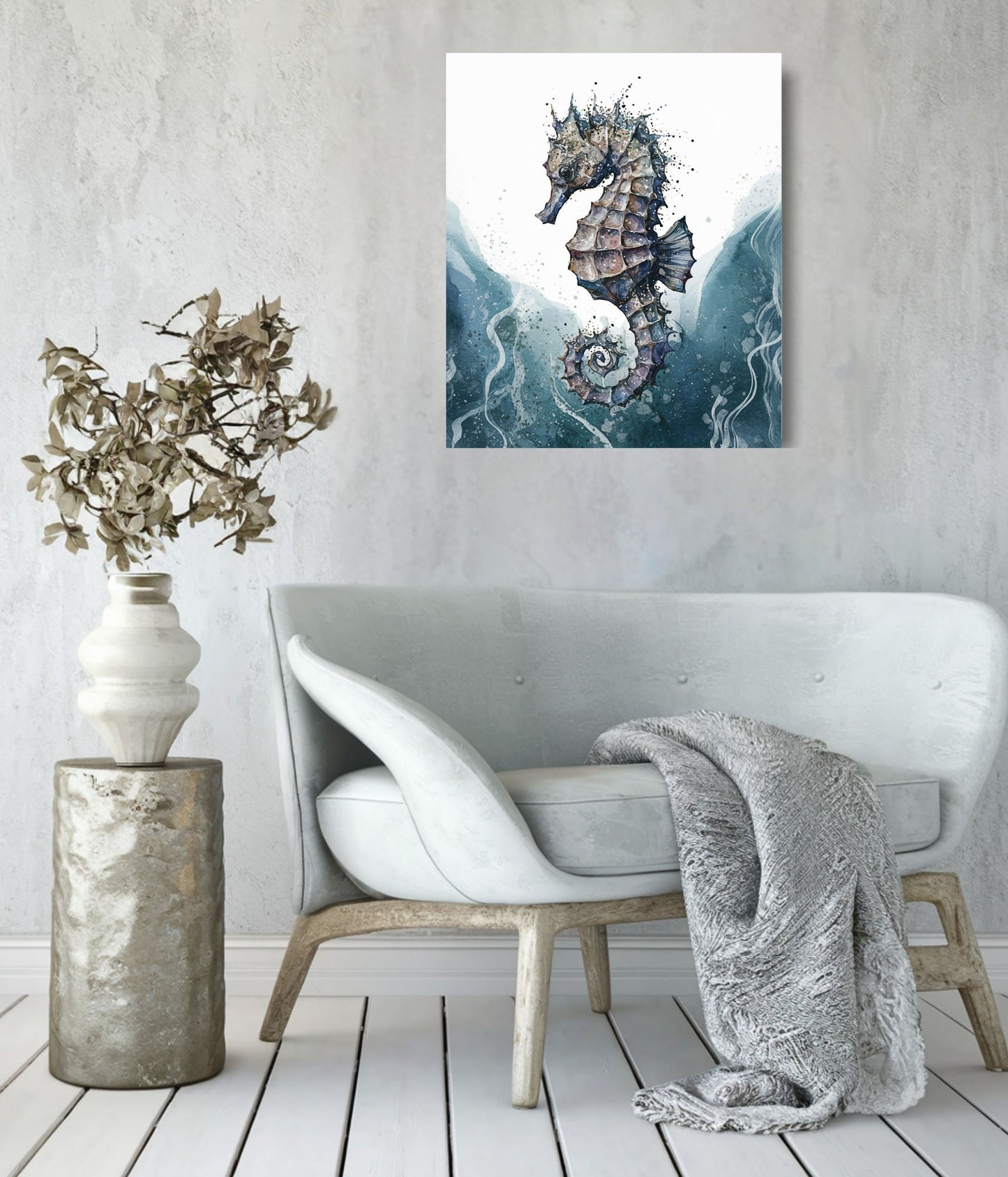 A vertical canvas art print of a seahorse hanging on a textured light gray wall above a modern white armchair with a gray throw blanket and a decorative vase on a wooden pedestal.