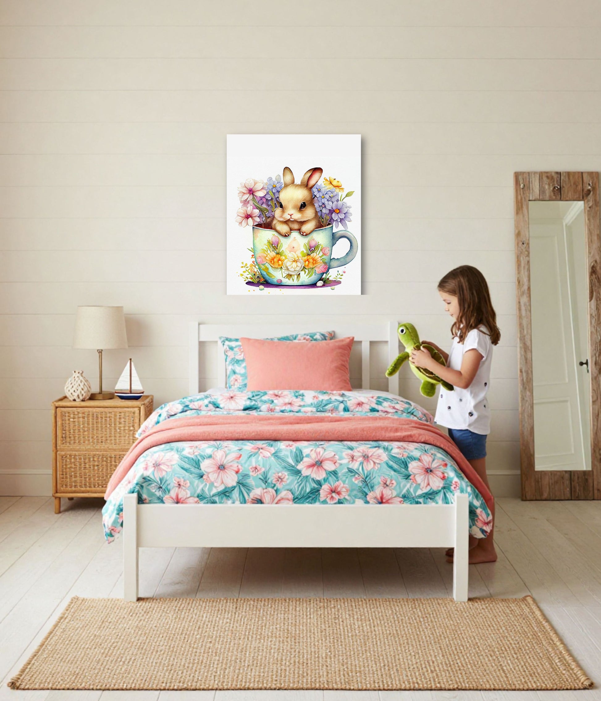 A child's bedroom scene with a white bed dressed in a pink and teal floral print, a coral throw blanket, and a matching pillow. A young girl stands beside the bed holding a green plush toy.